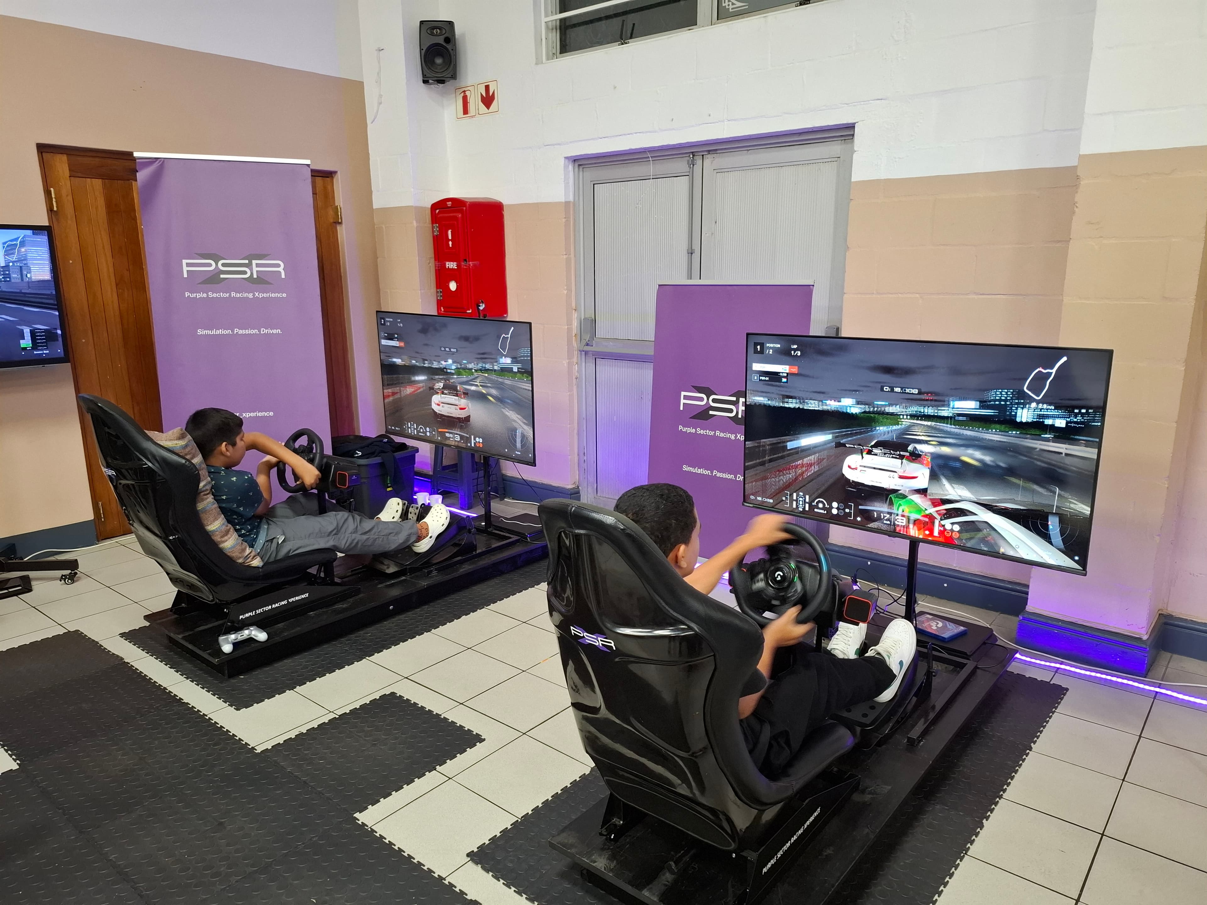 Guests racing on sim rigs